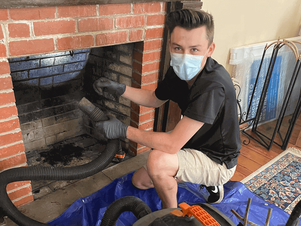 Chimney Sweep Michael Inspecting the inside of a fireplace in Jacksonville