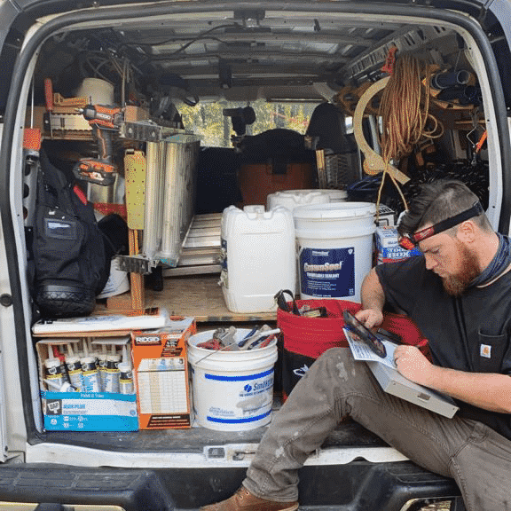 Our tech giving looking up a quote inside of a nicely kept van