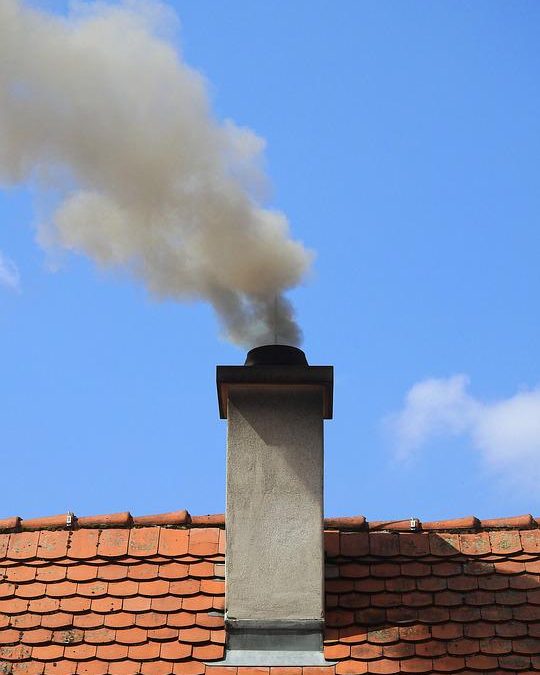 smoke rising out of a chimney