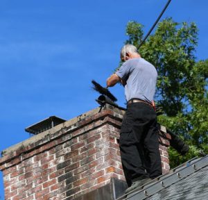 Technician Performing a Chimney Sweep