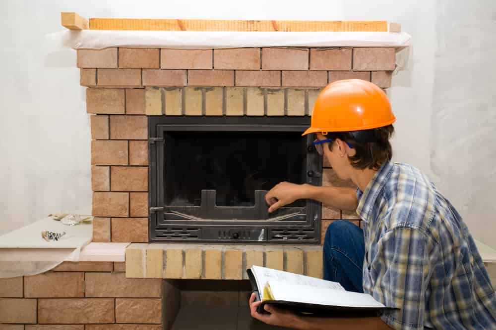 Inspecting the firebox for damage or needing repairs