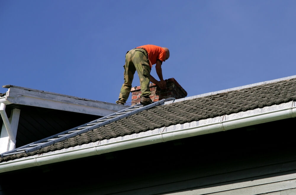 Seeing if theres water damage on the roof around the chimney